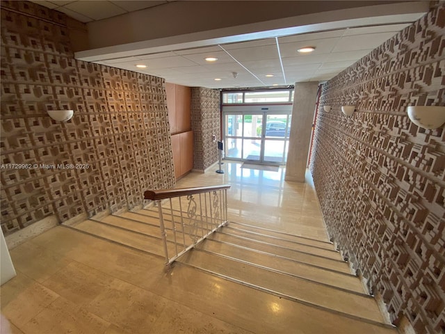 stairway featuring a paneled ceiling