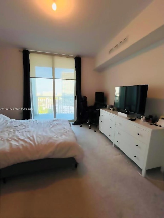 bedroom featuring light carpet and access to outside