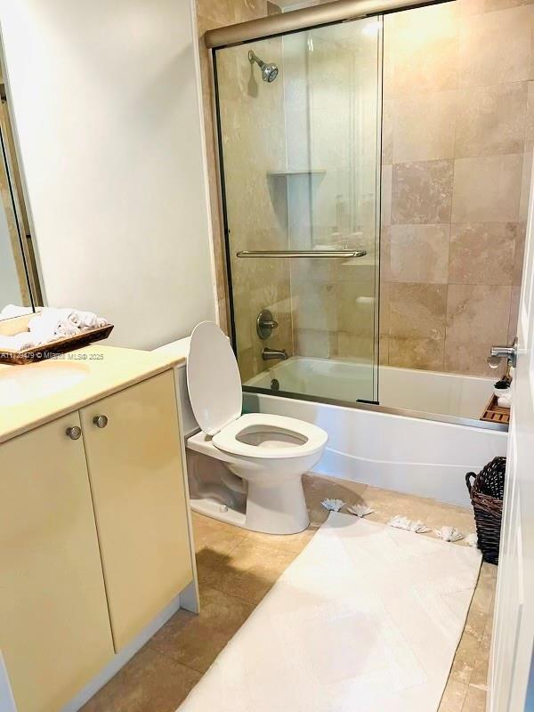 1755 E Hallandale Beach Blvd Unit 1605E, Hallandale Beach, FL 33009 - full bath featuring shower / bath combination with glass door, toilet, vanity, and tile patterned floors