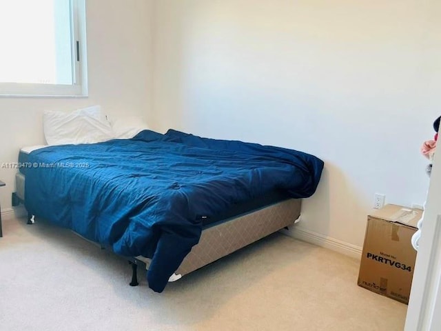bedroom with carpet floors and baseboards