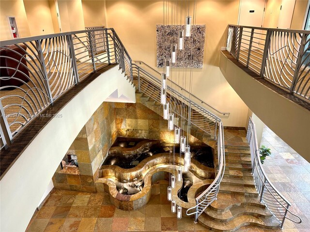 1755 E Hallandale Beach Blvd Unit 1605E, Hallandale Beach, FL 33009 - stairway featuring stone tile flooring and baseboards