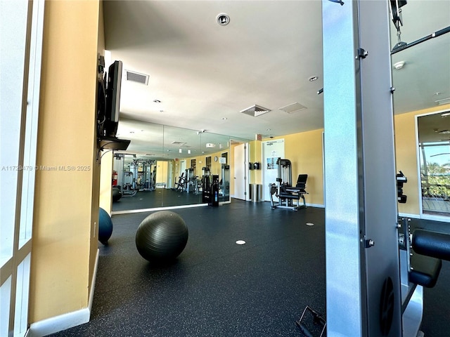 workout area featuring baseboards and visible vents