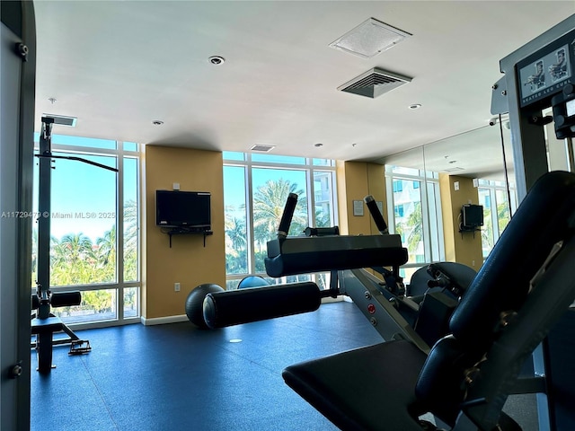 exercise room featuring a wealth of natural light, baseboards, visible vents, and recessed lighting