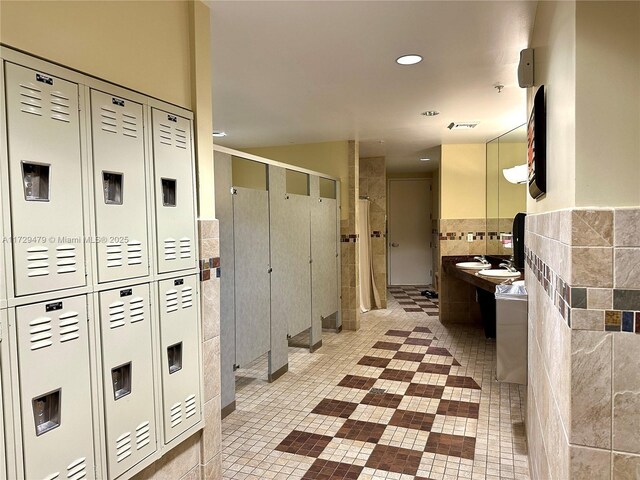 1755 E Hallandale Beach Blvd Unit 1605E, Hallandale Beach, FL 33009 - bathroom featuring tile walls, a stall shower, tile patterned flooring, vanity, and recessed lighting