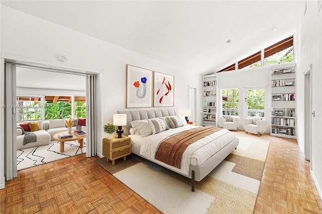 bedroom with high vaulted ceiling and multiple windows