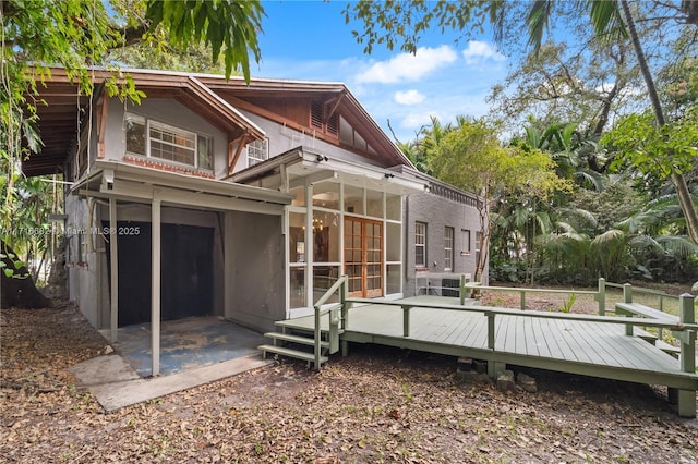 rear view of house with a wooden deck