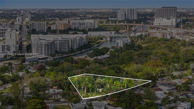 drone / aerial view featuring a view of city and a water view