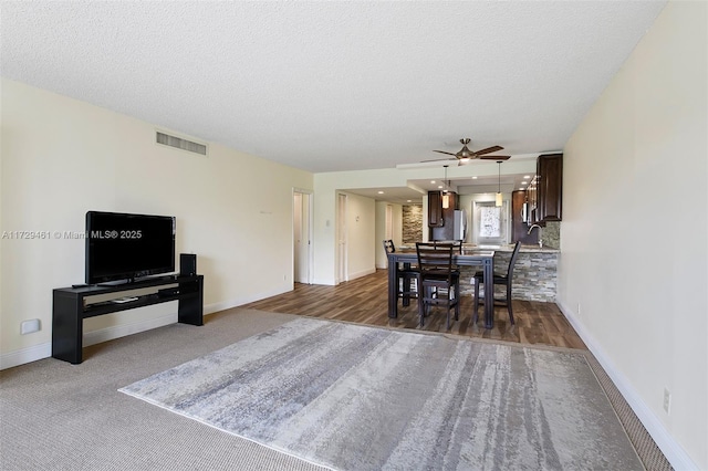 dining room featuring a textured ceiling and ceiling fan