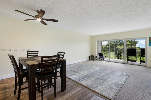 dining space featuring a textured ceiling and dark hardwood / wood-style flooring