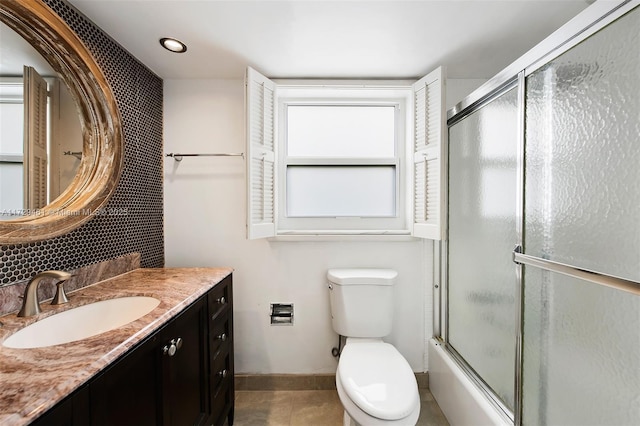 full bathroom featuring bath / shower combo with glass door, toilet, tile patterned flooring, and vanity