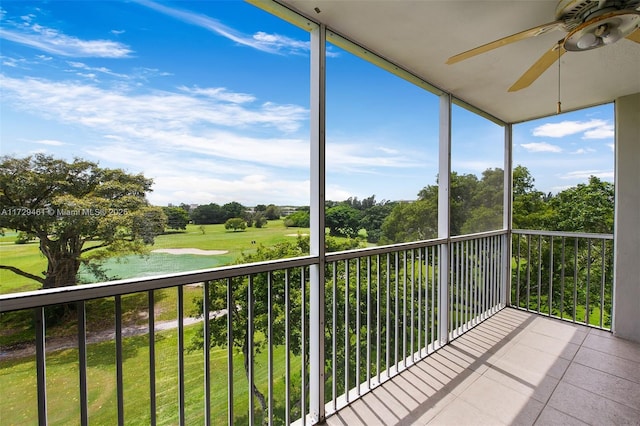 unfurnished sunroom featuring ceiling fan