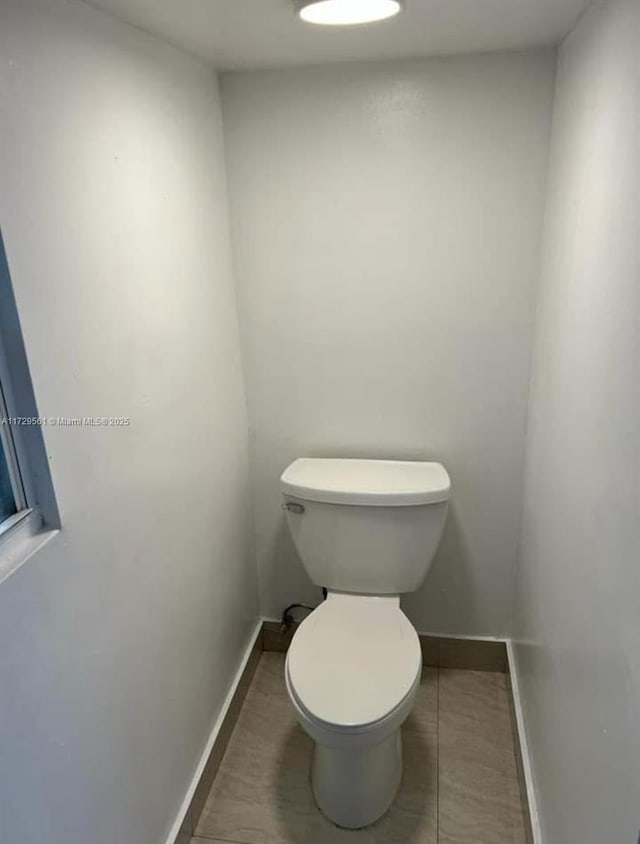 bathroom with tile patterned floors and toilet