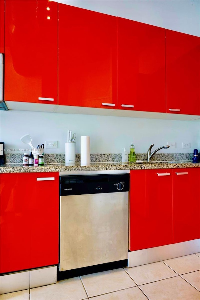 kitchen featuring dishwasher, sink, and light tile patterned flooring