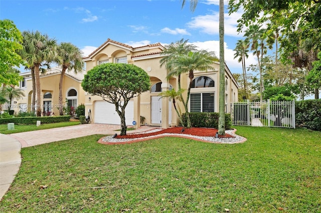 mediterranean / spanish home featuring a garage and a front yard