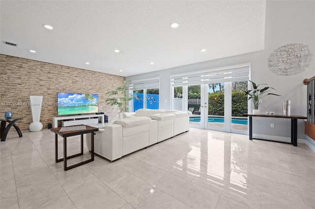 living room featuring french doors and a textured ceiling