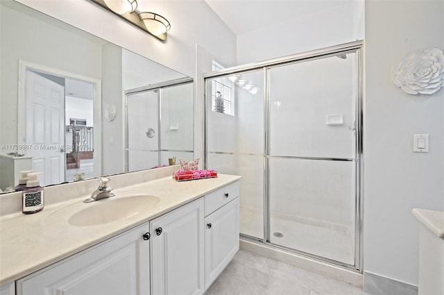 bathroom featuring walk in shower and vanity