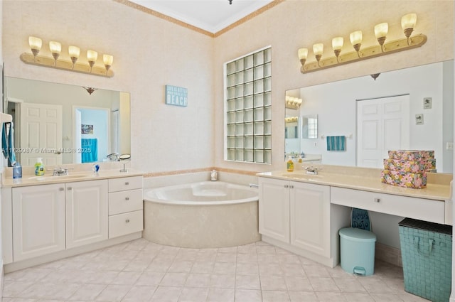 bathroom with vanity, ornamental molding, and a bath