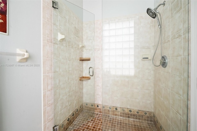 bathroom featuring a shower with door