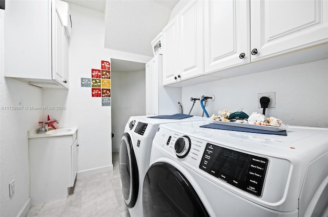 washroom featuring cabinets, light tile patterned flooring, washer and dryer, and sink