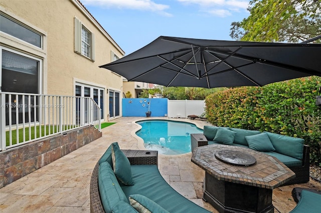 view of swimming pool featuring an outdoor living space with a fire pit and a patio