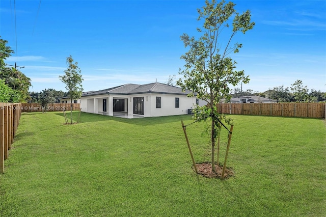 back of property with a patio and a lawn