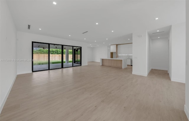 unfurnished living room with light hardwood / wood-style flooring