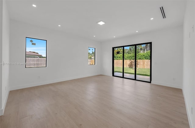 unfurnished room with light wood-type flooring