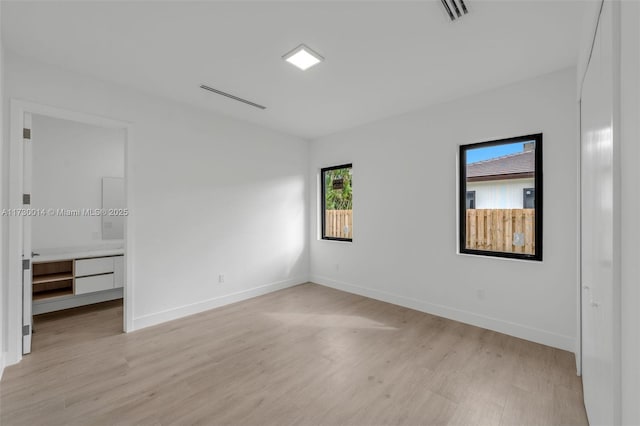 unfurnished room featuring light hardwood / wood-style floors