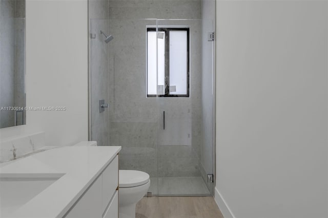 bathroom with vanity, toilet, and an enclosed shower