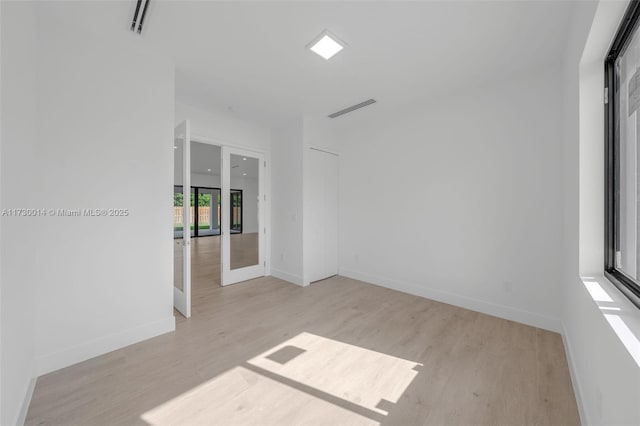 unfurnished room featuring light hardwood / wood-style floors