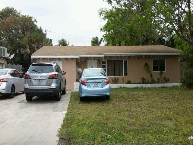 ranch-style house with a front lawn