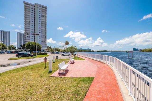 surrounding community featuring a water view and a yard