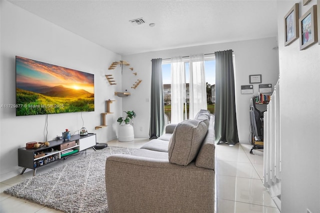 living room with light tile patterned floors and a textured ceiling