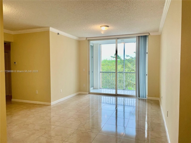 spare room with light tile patterned floors, ornamental molding, floor to ceiling windows, and a textured ceiling