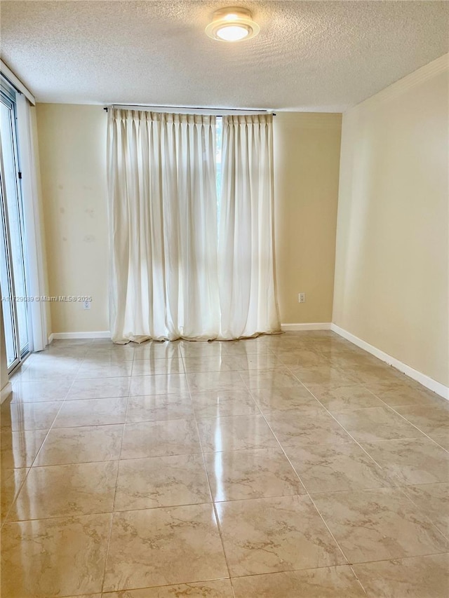 spare room featuring plenty of natural light and a textured ceiling