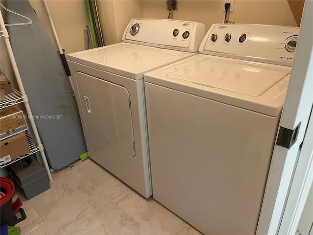 clothes washing area featuring washer and clothes dryer