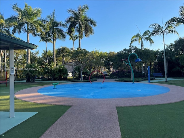 view of pool featuring a lawn