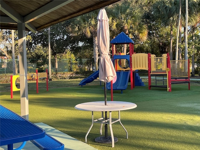 view of jungle gym featuring a lawn