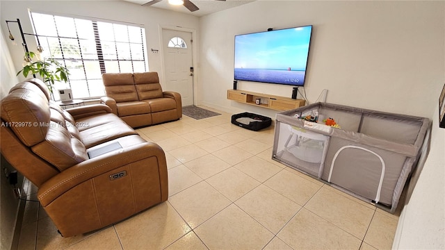 tiled living room with ceiling fan