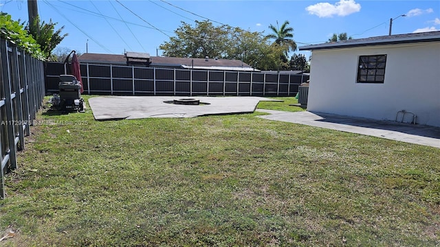 view of yard with an outdoor fire pit, a patio area, and a fenced backyard