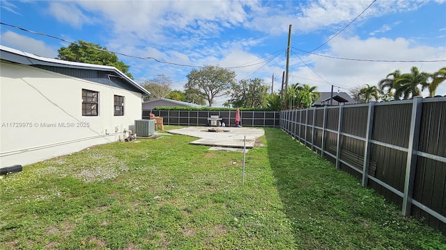 view of yard featuring cooling unit, a fenced backyard, and a patio