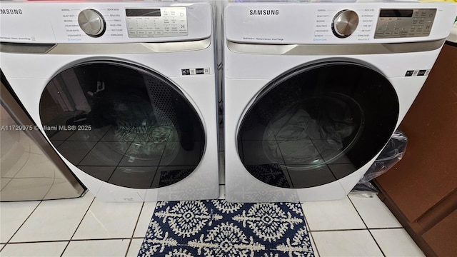 clothes washing area featuring washer and dryer, laundry area, and tile patterned floors