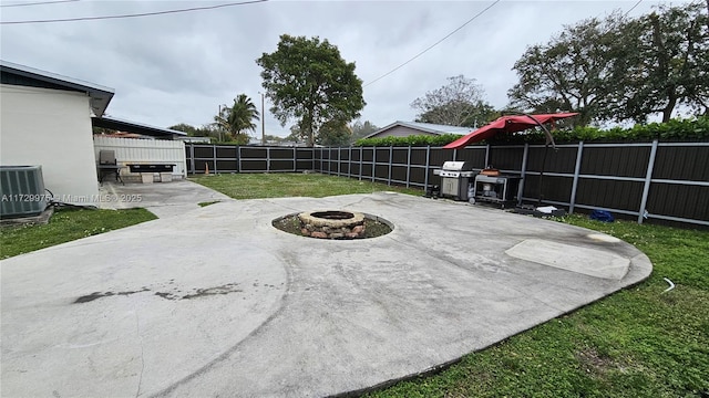 view of patio / terrace featuring an outdoor fire pit, a fenced backyard, grilling area, and central air condition unit