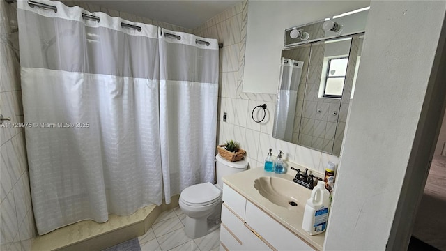 bathroom featuring toilet, curtained shower, vanity, and tile walls