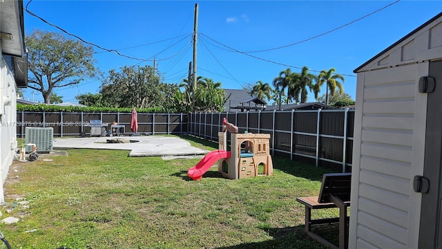 view of yard featuring a patio area, a playground, and a fenced backyard