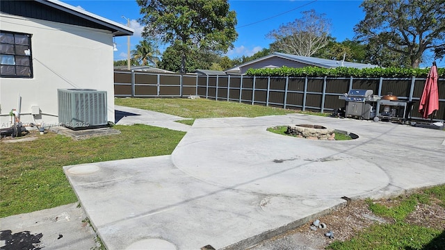 view of patio / terrace featuring an outdoor fire pit, fence, grilling area, and central AC unit