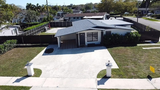 view of front of property with a front yard, a fenced backyard, and a residential view