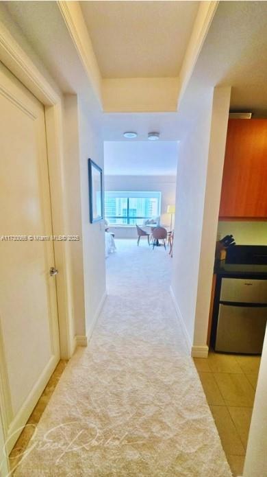 hallway featuring light tile patterned floors