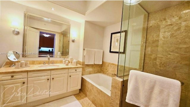 bathroom featuring vanity, tile patterned flooring, and separate shower and tub