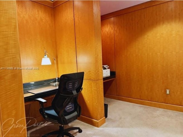 office with carpet flooring and wood walls